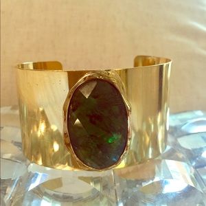 New gold metal cuff with a big green stone